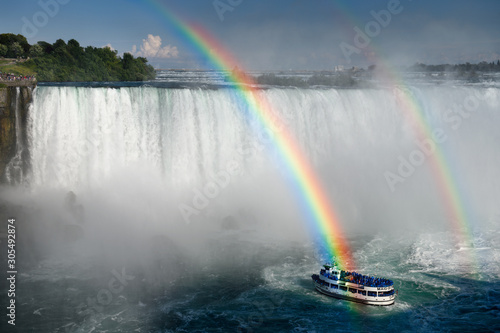 Double rainbow ending over Maid of the Mist tour boat at Horseshoe Falls at Niagara Falls Ontario Canada