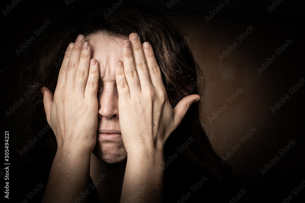 Upset woman covering face with hands Upset woman covering face with hands