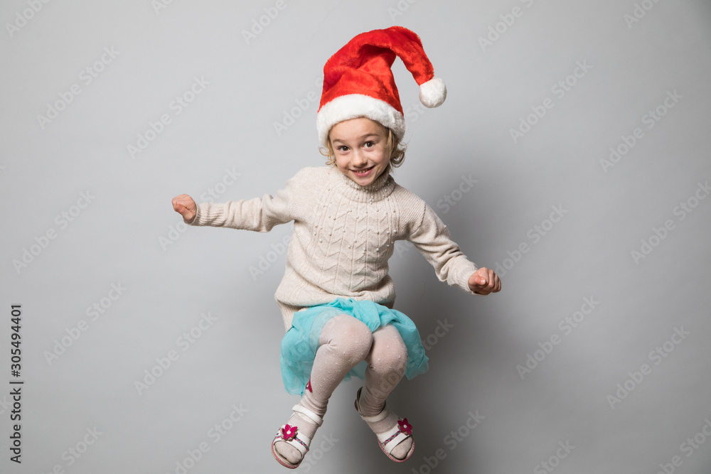 Smiling girl in the winter look on the grey Smiling girl in the winter look on the grey