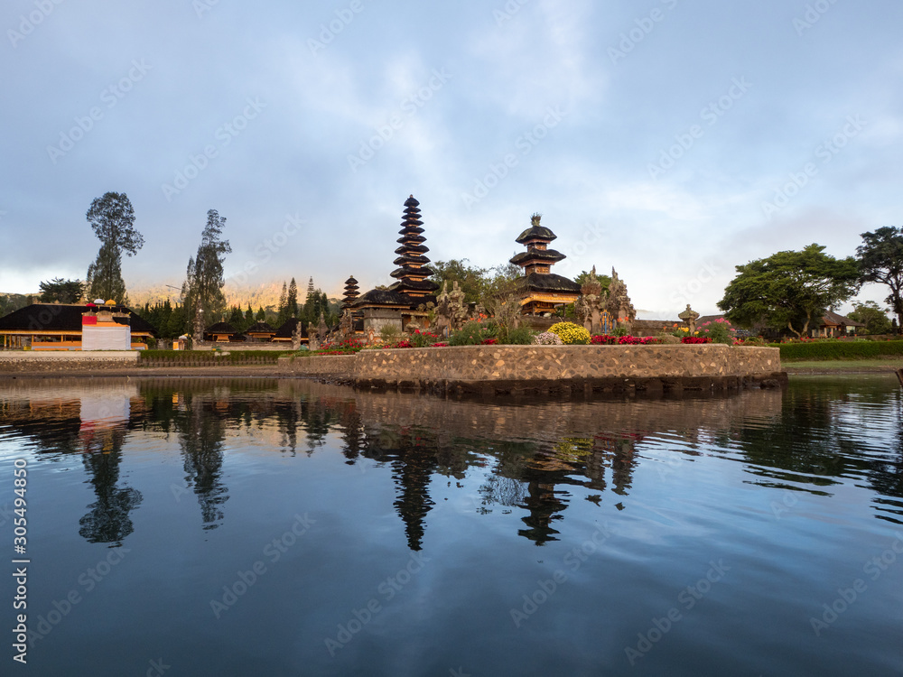 Naklejka premium Indonesia, november 2019: Sunrise in Pura Ulun Danu Bratan, or Pura Beratan Temple, Bali island, Indonesia. Pura Ulun Danu Bratan is a major Shivaite and water temple on Bali island