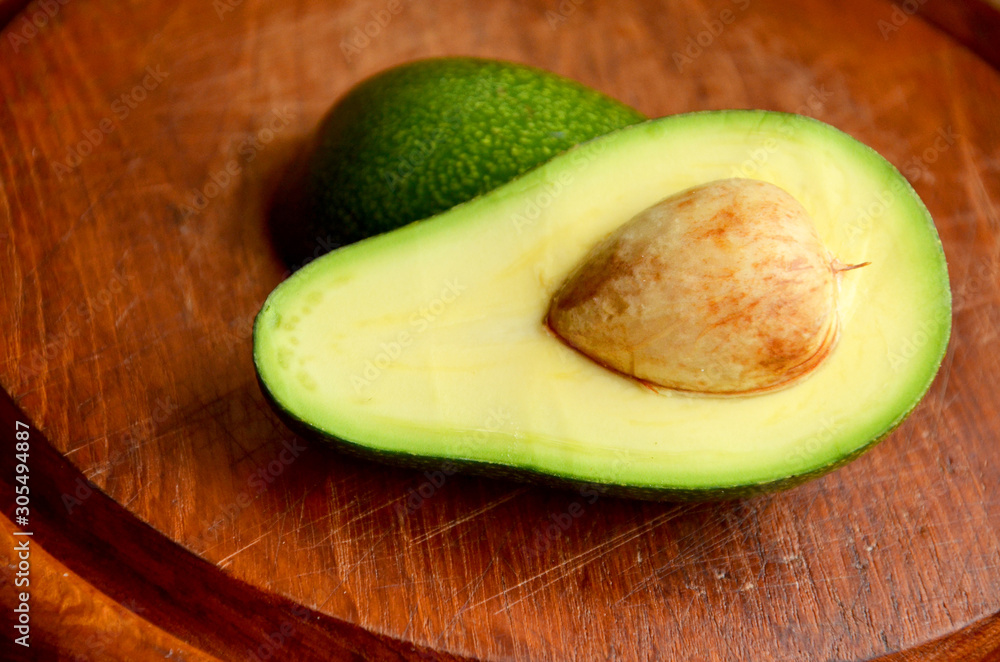avocado on wooden background fresh avocado on a wooden plate