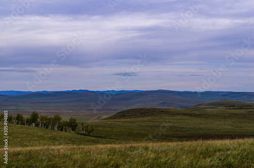 Hills. Sky. The clouds. The boundless steppe. The trees.