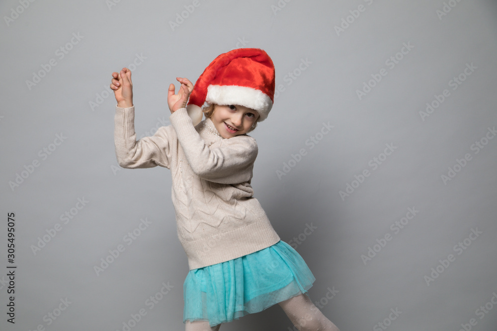 Smiling girl in the winter look on the grey Smiling girl in the winter look on the grey