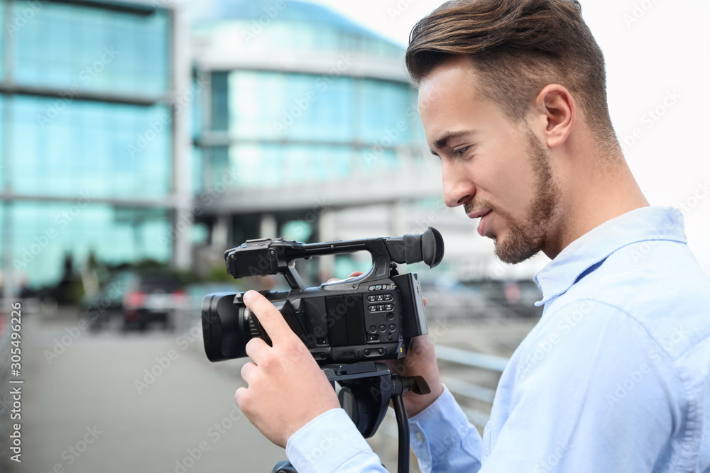 Video operator with camera working on city street Video operator with camera working on city street