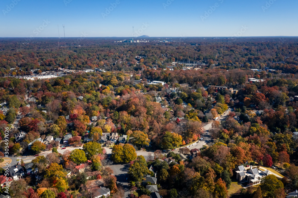 Aerial picture of houses in Midtown Atlanta during the fall and Stone Mountain in the background