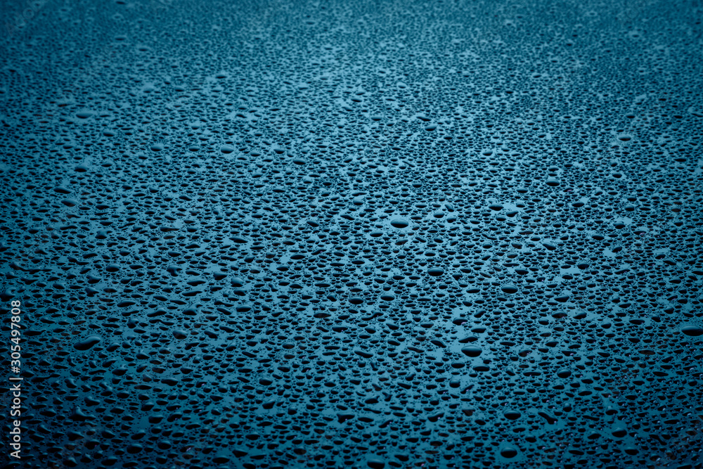 Water drops on dark surface.