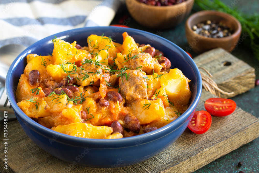 Thanksgiving Autumn Menu. Stew with beans and vegetables in a bowl on a rustic table. Thanksgiving Autumn Menu. Stew with beans and vegetables in a bowl on a rustic table.