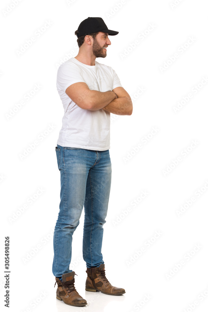 Smiling Casual Man Black Cap Is Standing With Arms Crossed And Looking Away Smiling Casual Man Black Cap Is Standing With Arms Crossed And Looking Away