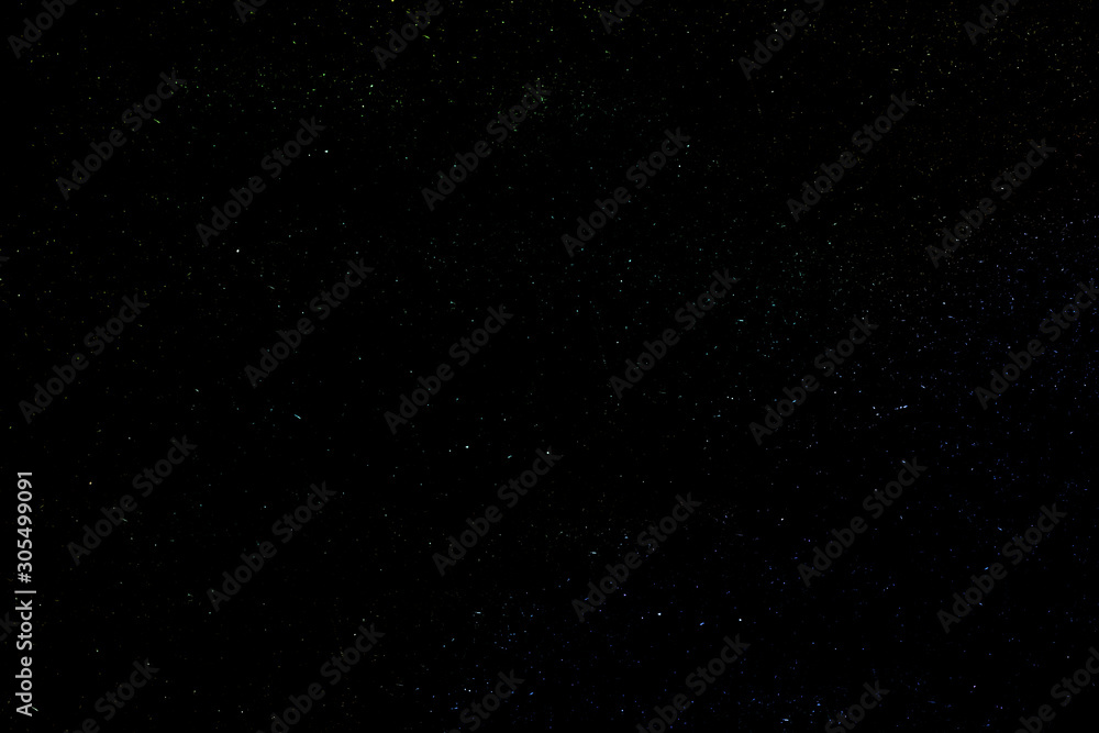 Background of the night clear sky with luminous multi-colored stars.