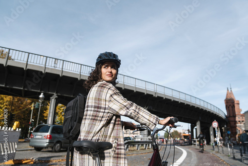 Woman with a bicycle in the city, Berlin, Germany