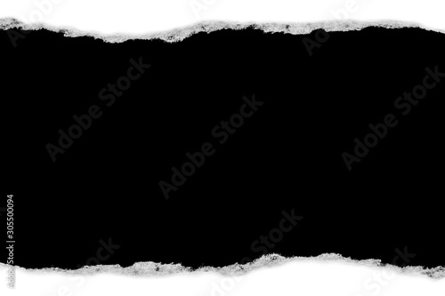 White paper with torn edges isolated with a black isolated background inside.