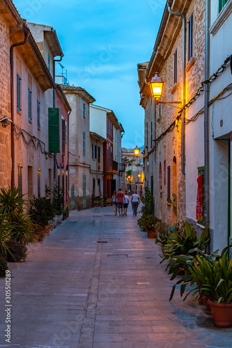 Night or blue hour view of a narrow street in the old town of Alcudia  Mallorca  Spain