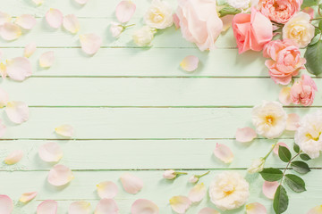 pink and white roses on green wooden background