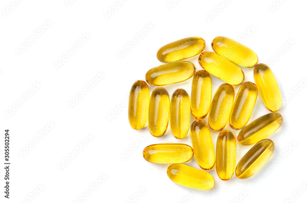 Fototapeta premium Group of yellow vitamin capsules on white background