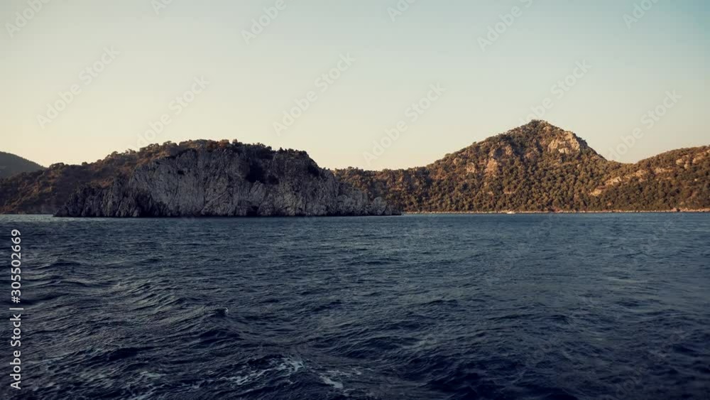 Sea View From Boat At Sunset.Slow Motion View Sea Wave Behind Pleasure Boat In Sunset.Pleasure Boat Sailing In The Mediterranean Sea In Turkey Coast.Travel And Trip Concept. Sea View From Boat At Sunset.Slow Motion View Sea Wave Behind Pleasure Boat In Sunset.Pleasure Boat Sailing In The Mediterranean Sea In Turkey Coast.Travel And Trip Concept.