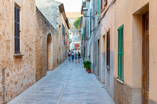 Fototapeta Naklejka Na Ścianę i Meble -  Beautiful narrow historic streets of Alcudia Old Town in Majorca Mallorca