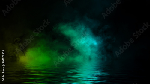 Abstract multi color fog smoke effects on isolated black background with rerflection in water . Creative texture. Design element.