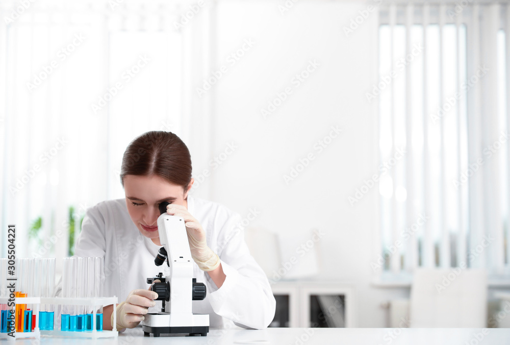 Scientist using modern microscope at table. Medical research Scientist using modern microscope at table. Medical research