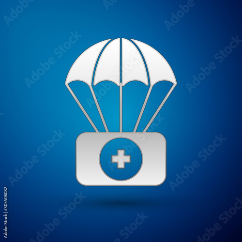 Silver Parachute with first aid kit icon isolated on blue background. Medical insurance. Vector Illustration