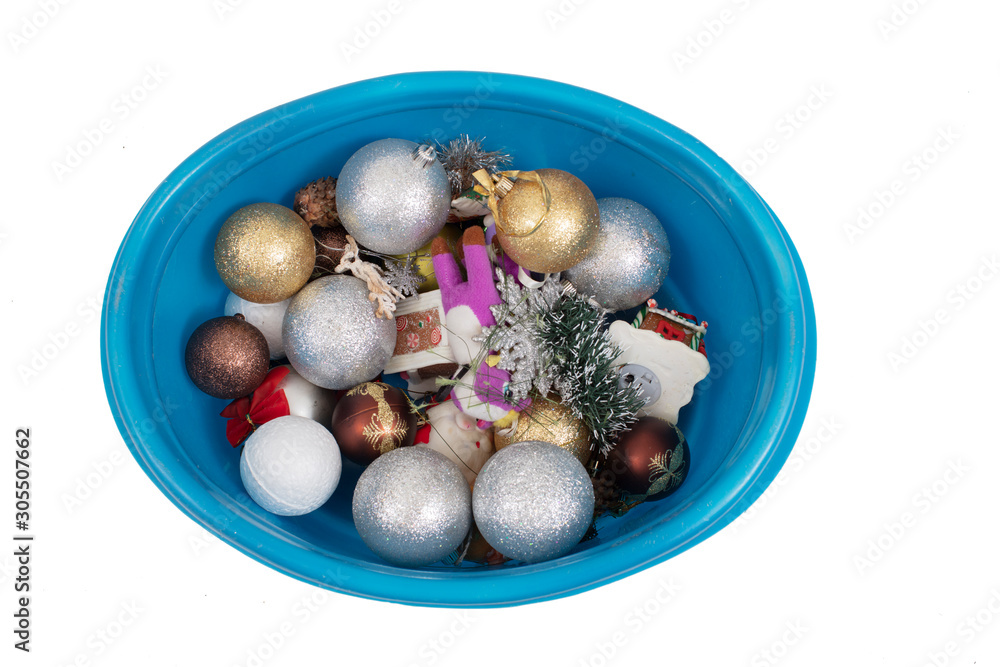 Christmas toys in a basin on a white background
