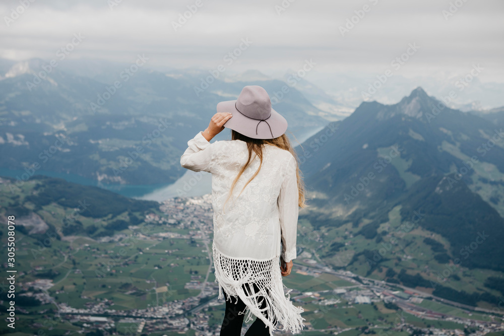 Rear view of woman on viewpoint, Grosser Mythen, Switzerland Rear view of woman on viewpoint, Grosser Mythen, Switzerland