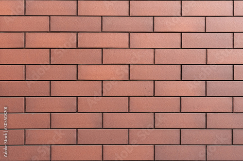 Wall texture of new modern brown brick. Building surface background. Classic brickwall.