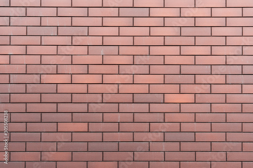 Wall texture of new modern brown brick. Building surface background. Classic brickwall.