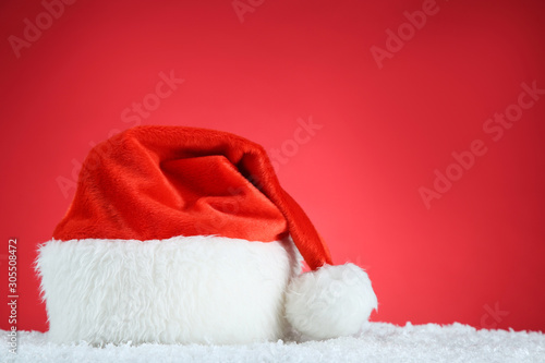 Red santa hat with white snow on red background