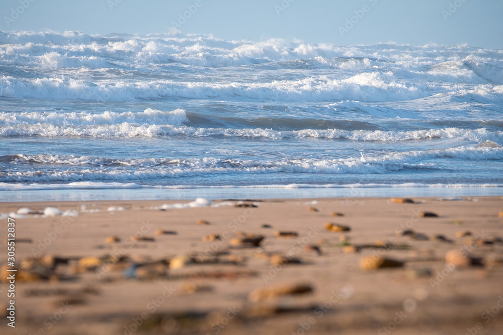 Sandy coast of the Atlantic Ocean and surf waves in Morocco