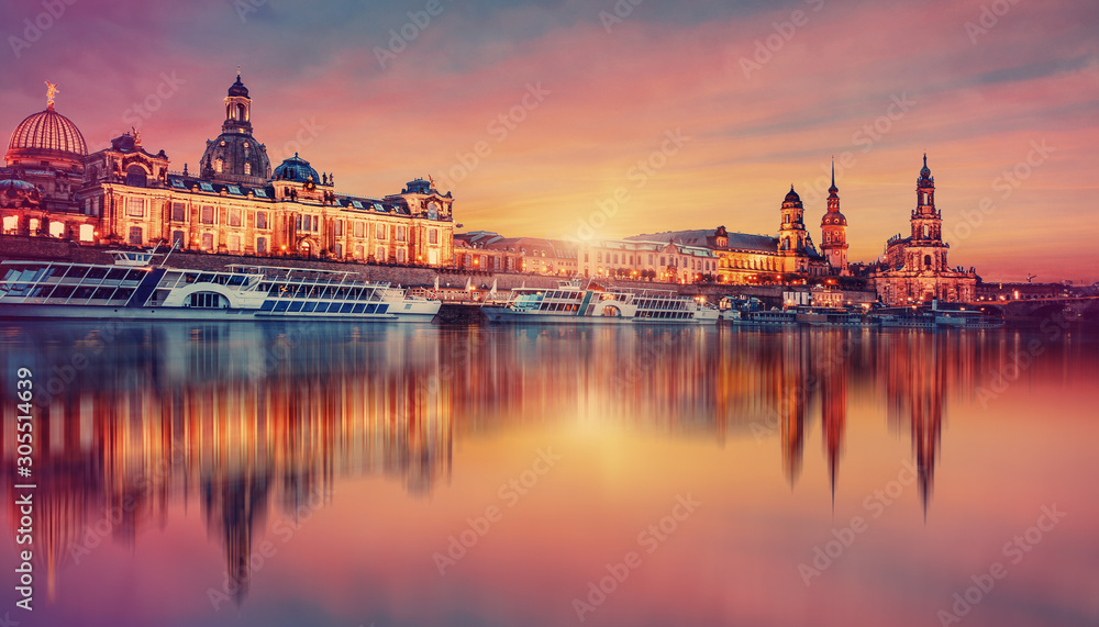 Fototapeta premium Awesome colorful scene during sunset at the Old Town in Dresden, Saxony, Germany. Famouse Sights: Frauenkirche, Hofkirche, Semperoper with reflected in calm water Elbe river. picturesque scenery.
