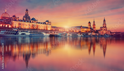 Awesome colorful scene during sunset  at the Old Town in Dresden, Saxony, Germany. Famouse Sights: Frauenkirche, Hofkirche, Semperoper with reflected in calm water  Elbe river. picturesque scenery. © jenyateua