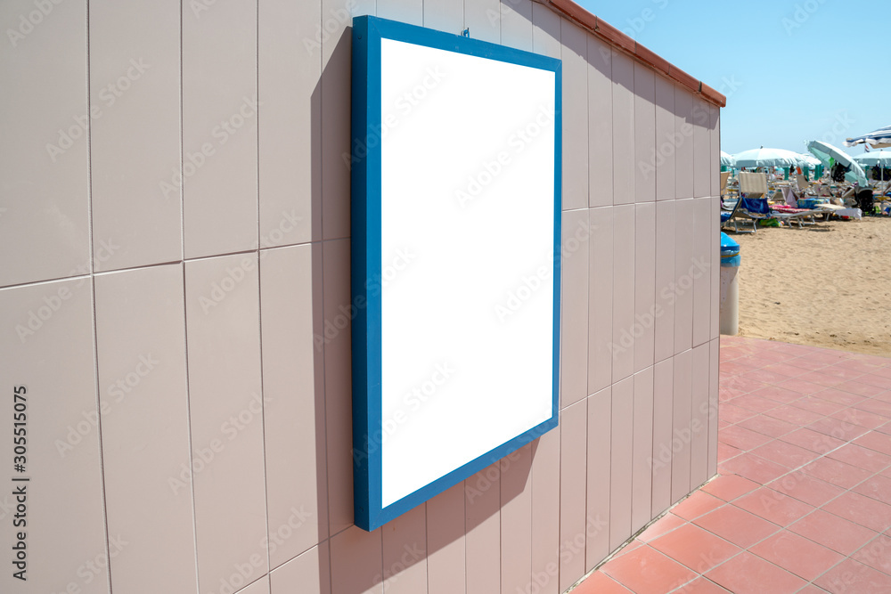 empty white poster in blue frame hanging on wall of sea beach entrance, mock-up empty white poster in blue frame hanging on wall of sea beach entrance, mock-up
