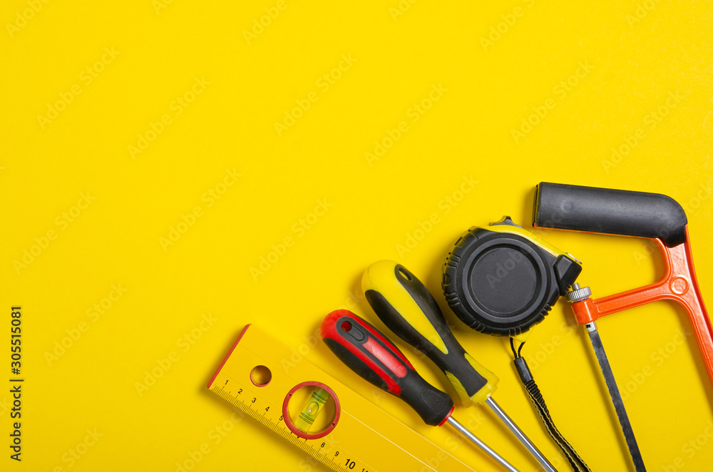 Work hand tools on yellow background. Top view composition. Work hand tools on yellow background. Top view composition.