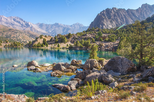 Beautiful mountain nature landscape on sunny summer day. Alaudin lake in Fann mountains, Tajikistan. Scenic with on blue water in lakes in Pamir-Alay valley photo
