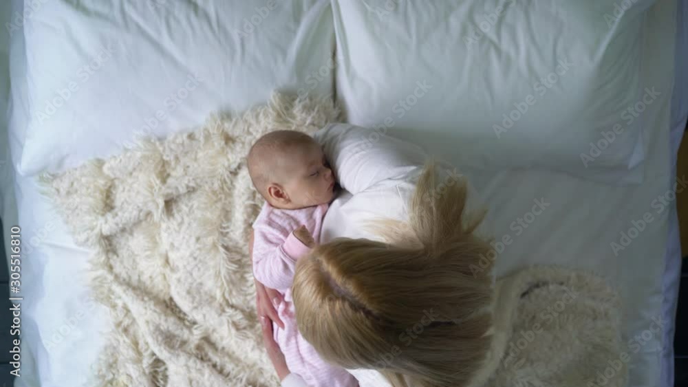 Loving mother cradling sweet newborn baby in arms, happy motherhood, tenderness Loving mother cradling sweet newborn baby in arms, happy motherhood, tenderness