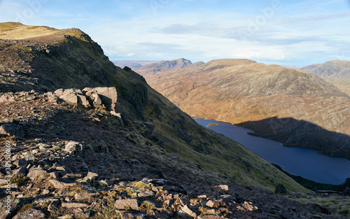 Steep sides of the ridge that leads to Sgurr an Tuill Bhain with Lochan Fada below in the Scottish Highlands. photo