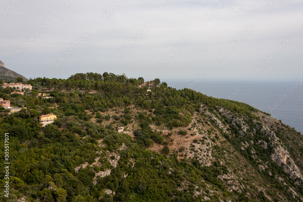 Landscape with high hill over the sea. Houses and forrest seen from Eze Village, French Riviera. 