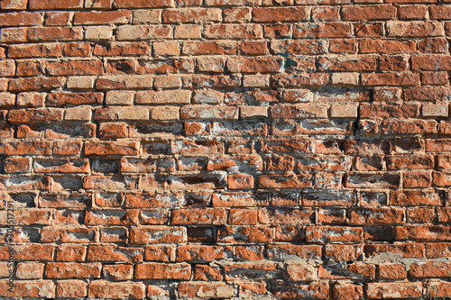 Background - old red brick wall with some ruined bricks