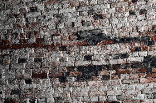 Old brick wall with some ruined white and black bricks in dungeon