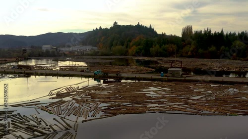 Sawmill at Sunset, Aerial Fly By of the Coquille, Oregon Logging Boom on the River photo