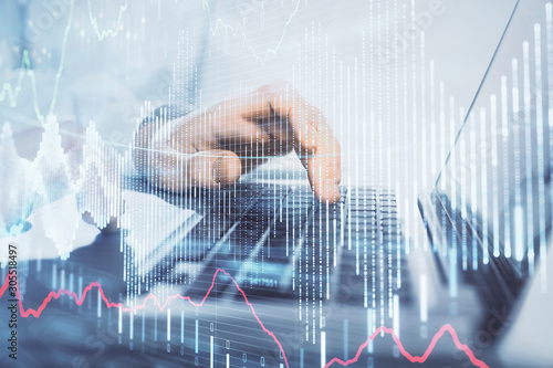 Double exposure of market chart with man working on computer on background. Concept of financial analysis.