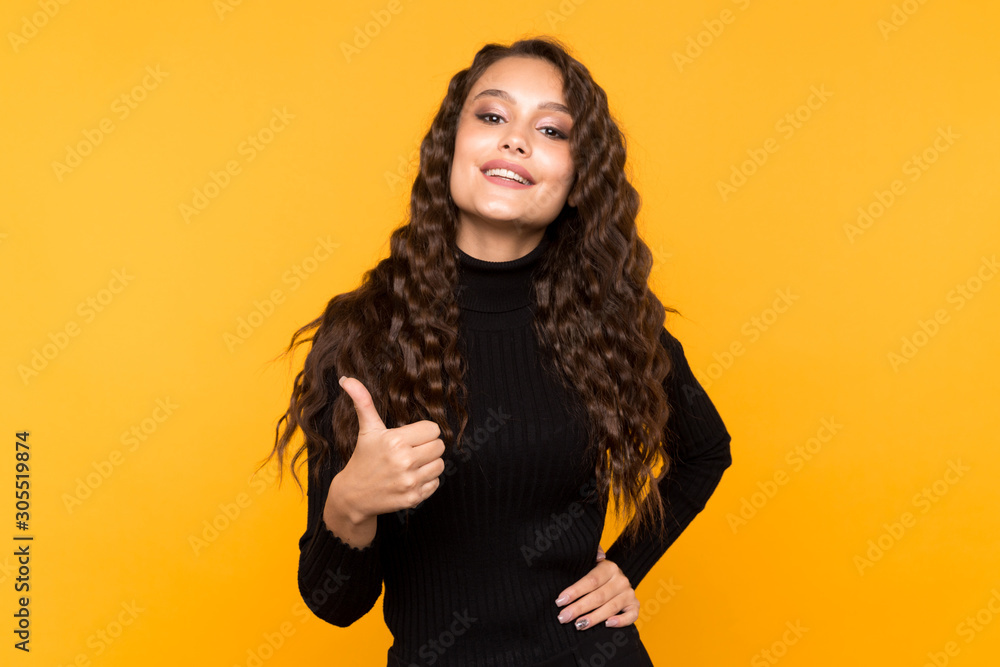 Beautiful brunette woman in the black clothes showing thumb up Beautiful brunette woman in the black clothes showing thumb up