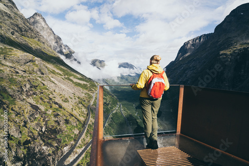 Scandinavian woman enjoying the view over Trollstigen mountain road in More og Romsdal, Norway photo