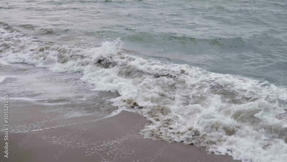 Waves crash and rush up the sandy beaches of the San Francisco bay on a summer afternoon Waves crash and rush up the sandy beaches of the San Francisco bay on a summer afternoon
