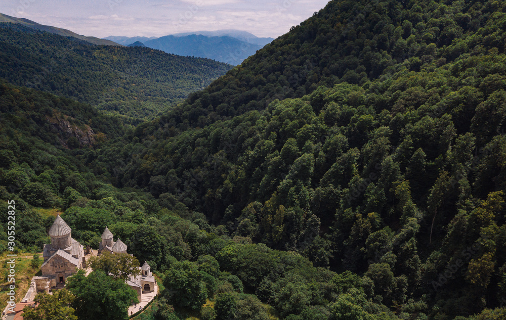 Haghartsin Monastery in Caucasus mountains. Old Armenian church from aerial view. Orthodox church in forest valley. Nature landscape. Dilijan, Armenia
