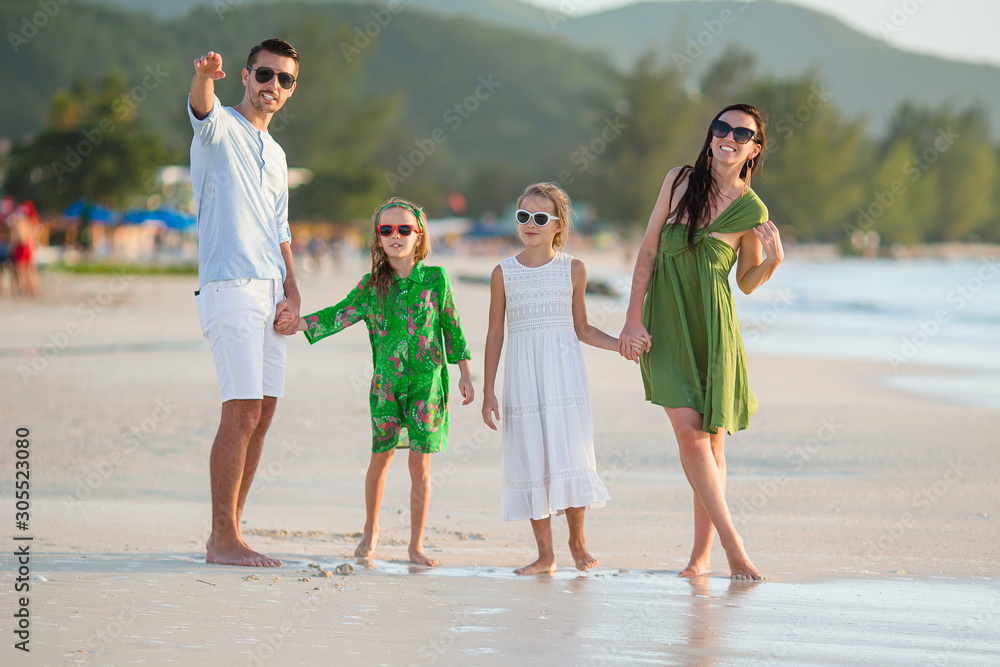 Young family on vacation on tropical beach Young family on vacation on tropical beach
