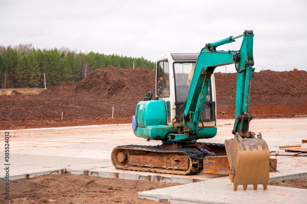 Construction excavator at construction work. Special machinery Construction excavator at construction work. Special machinery