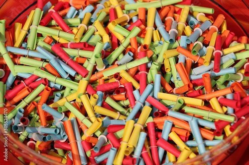 many colorful tombola tickets are lying in a bowl