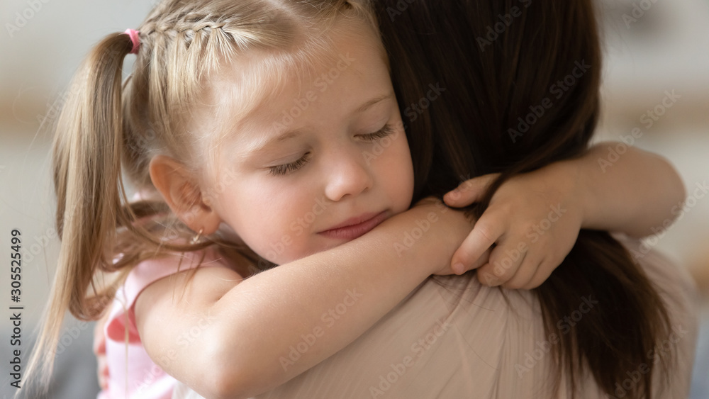 Grateful little child girl cute face embrace loving foster mother Grateful little child girl cute face embrace loving foster mother