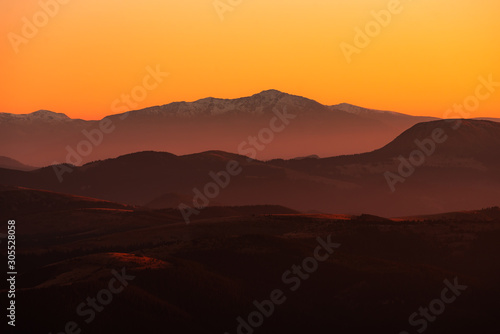 Sunset mountain peaks covered with snow . Carpathians mountain peaks sunset view. Sunset mountain peaks silhouette.
